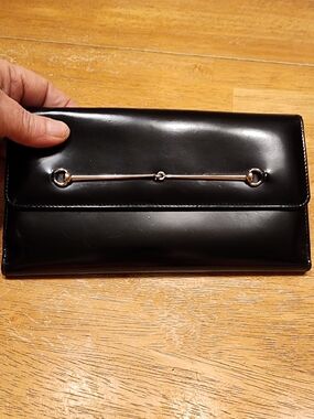 vintage Gucci black patent leather continental wallet featuring horsebit